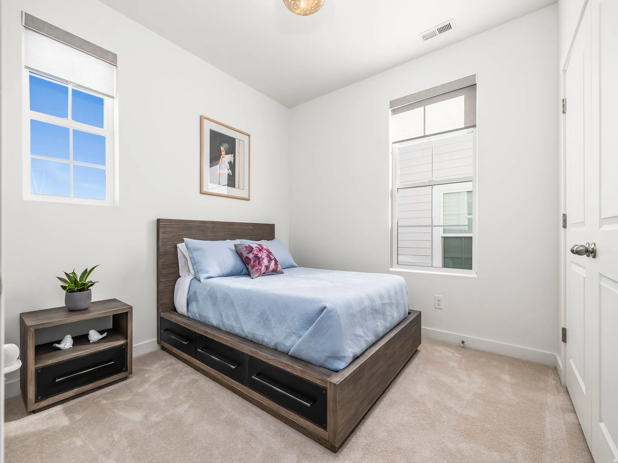 Bedroom featuring light carpet