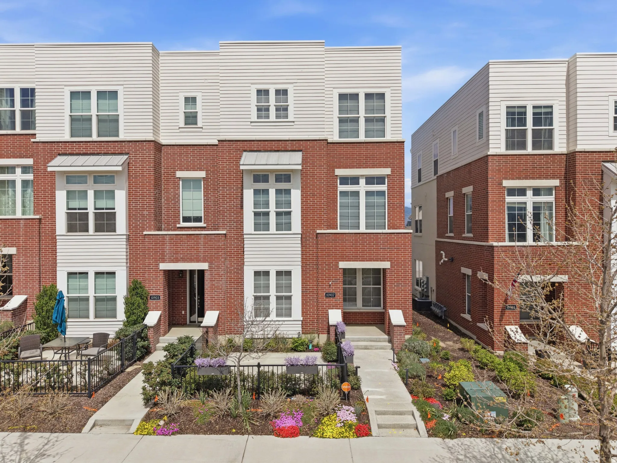 Multi-story townhome featuring brick and horizontal siding facade