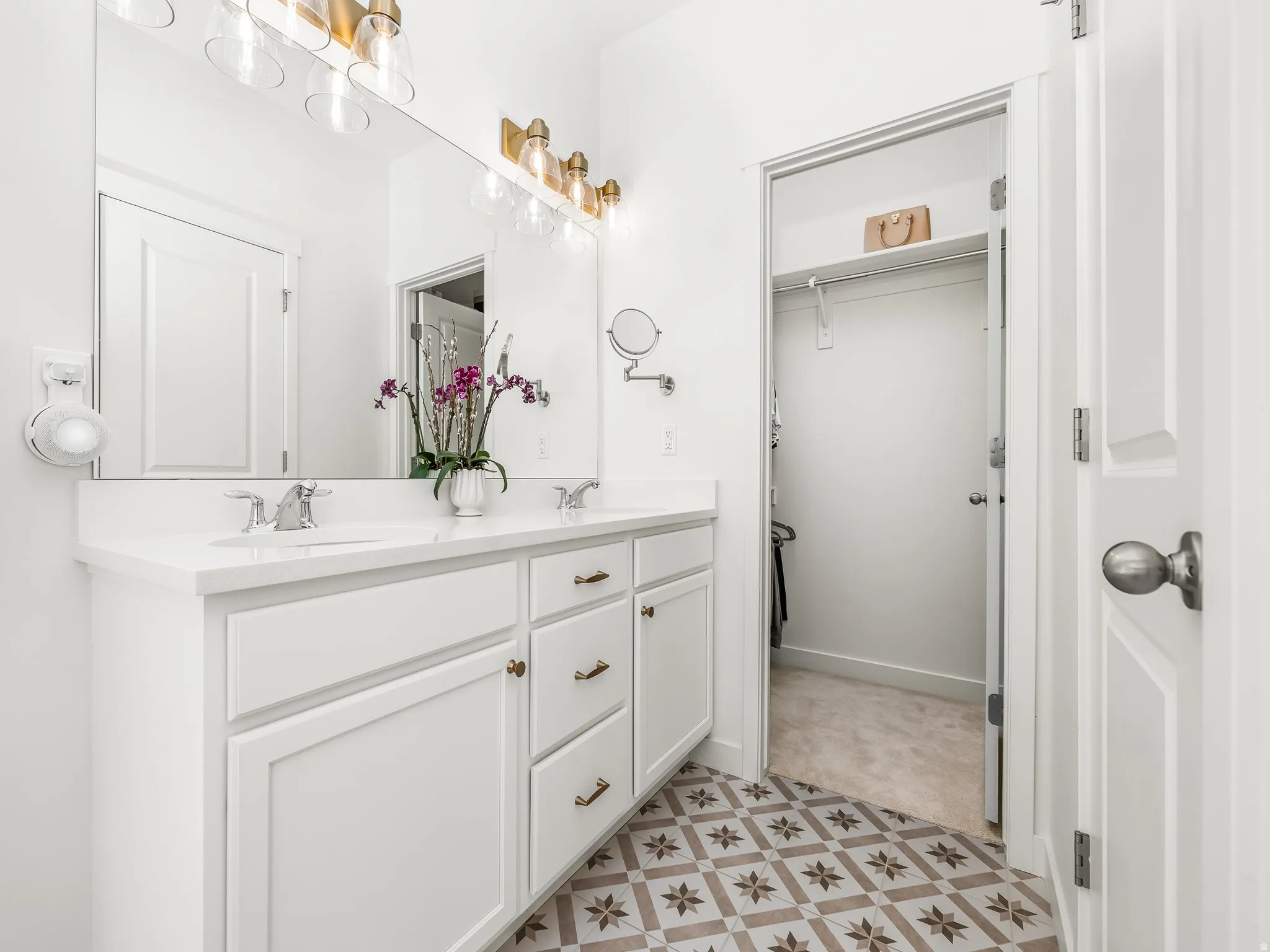 Full bathroom featuring double vanity and a spacious closet