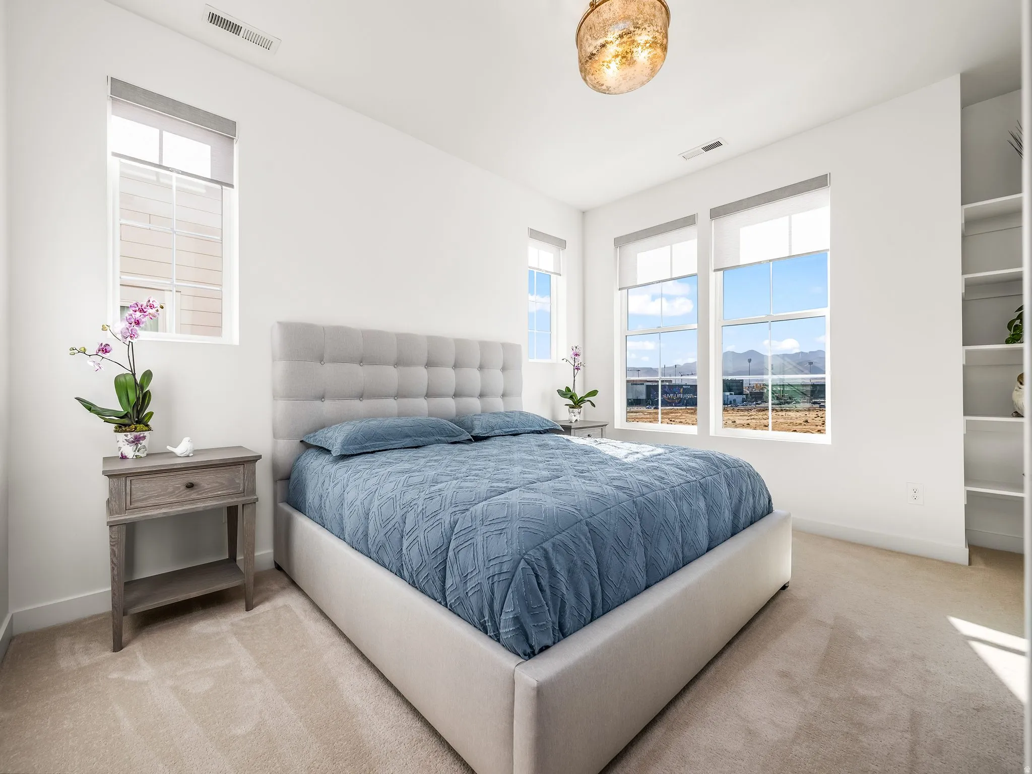 Bedroom featuring light carpet