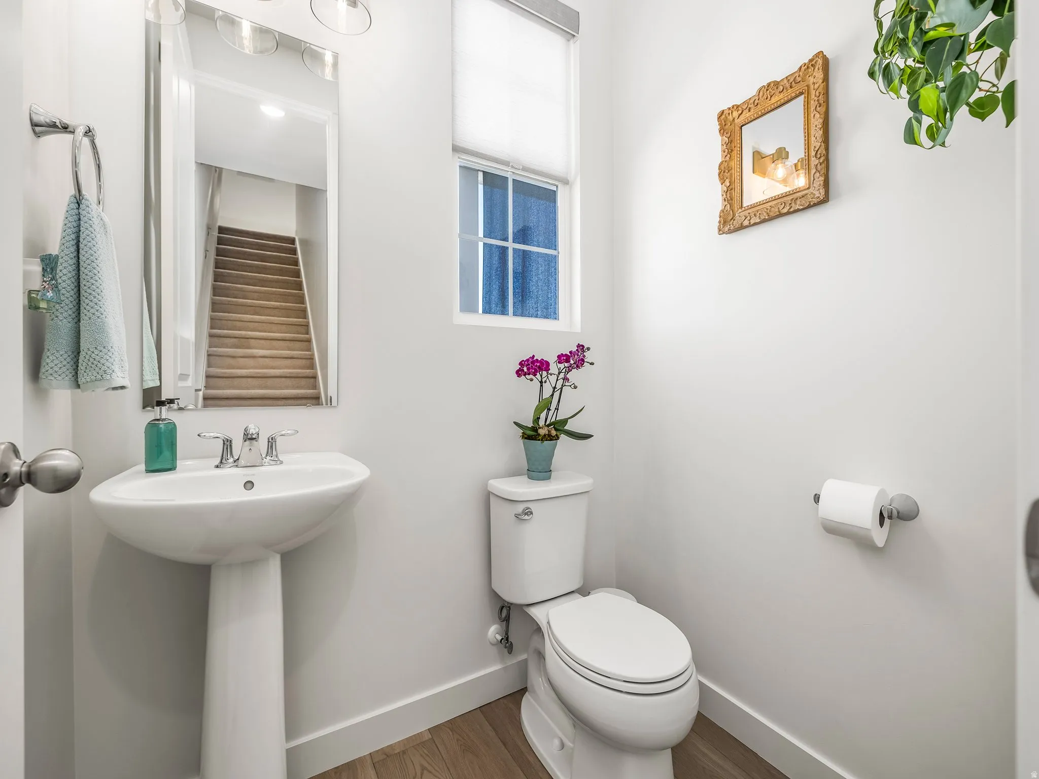 Bathroom featuring baseboards and wood finished floors
