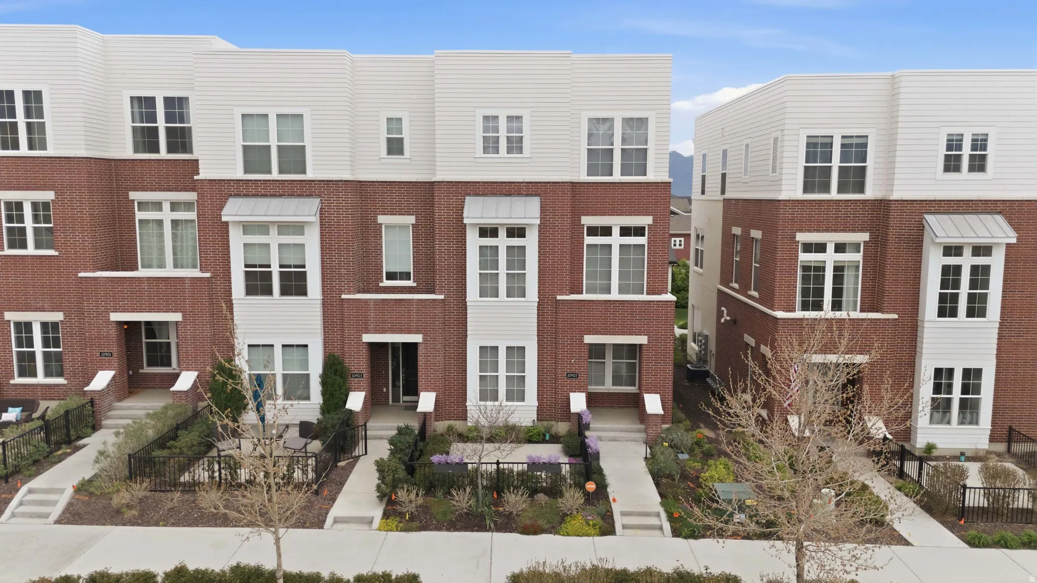 Contemporary townhomes featuring brick and horizontal siding exteriors