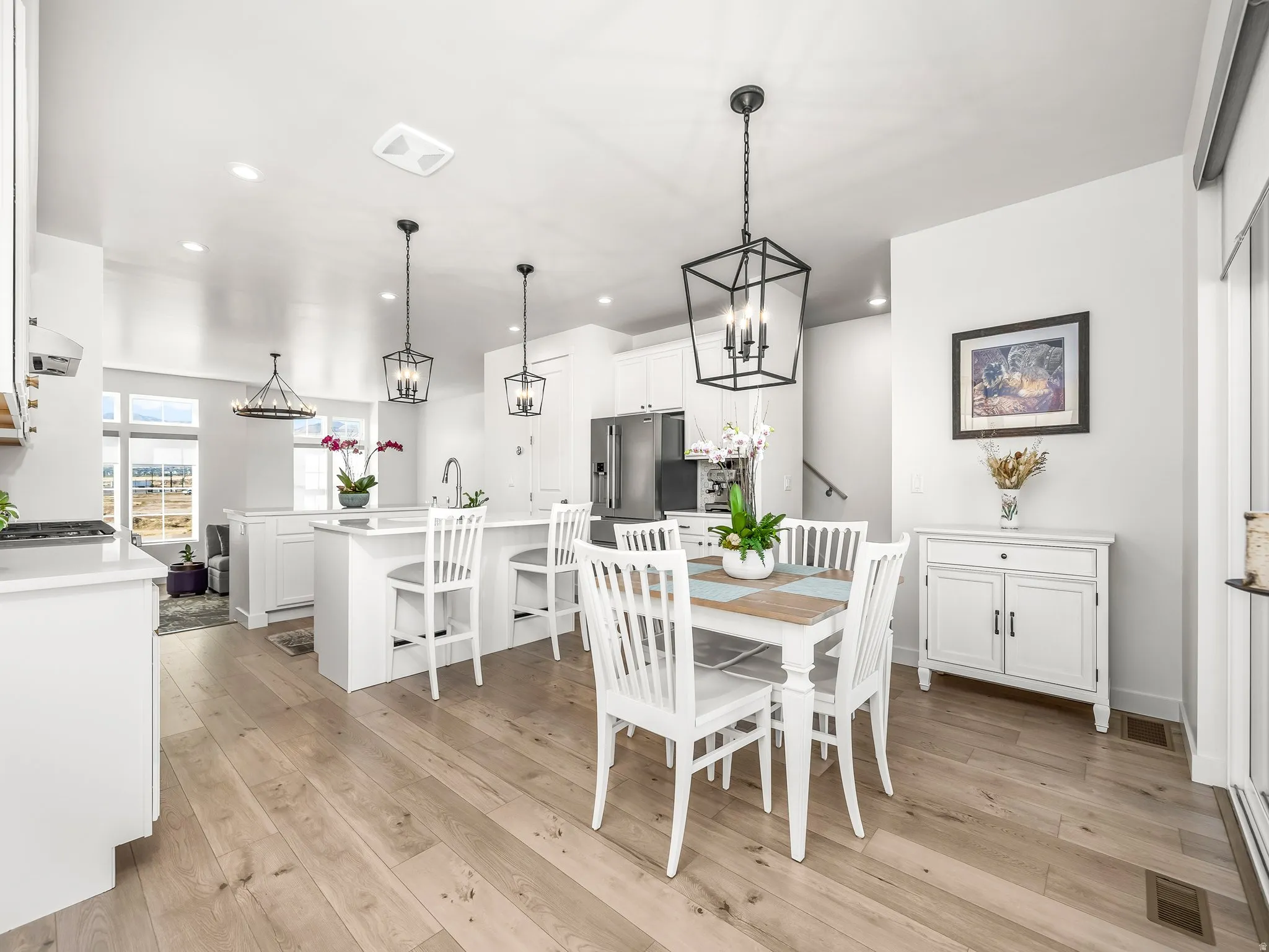 Dining space with light wood finished floors, recessed lighting, and a chandelier