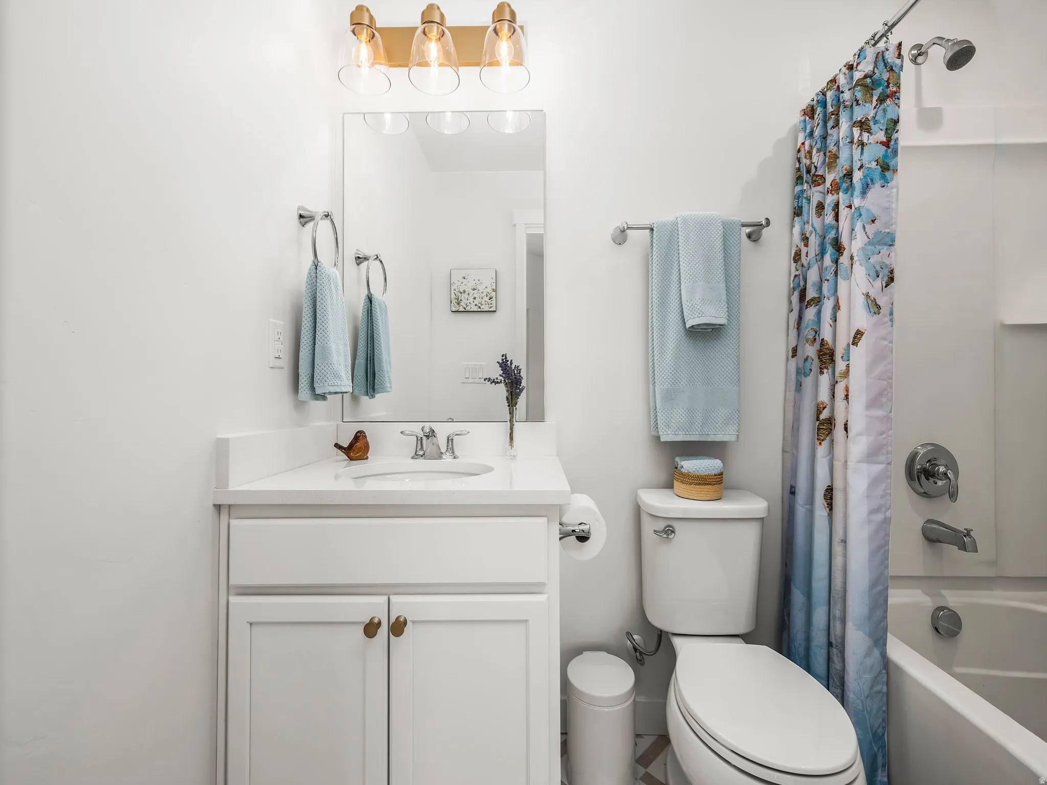 Bathroom with shower / bath combo with shower curtain and vanity