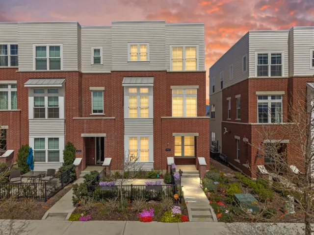 Modern townhome featuring a brick facade with horizontal siding accents