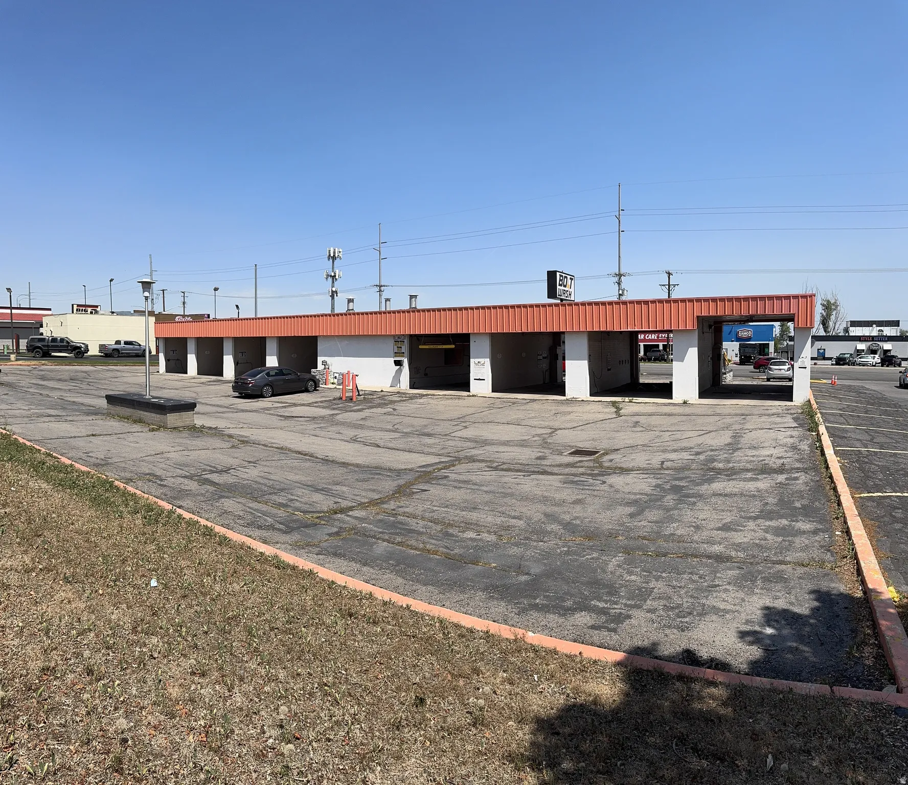 View of commercial property featuring uncovered parking