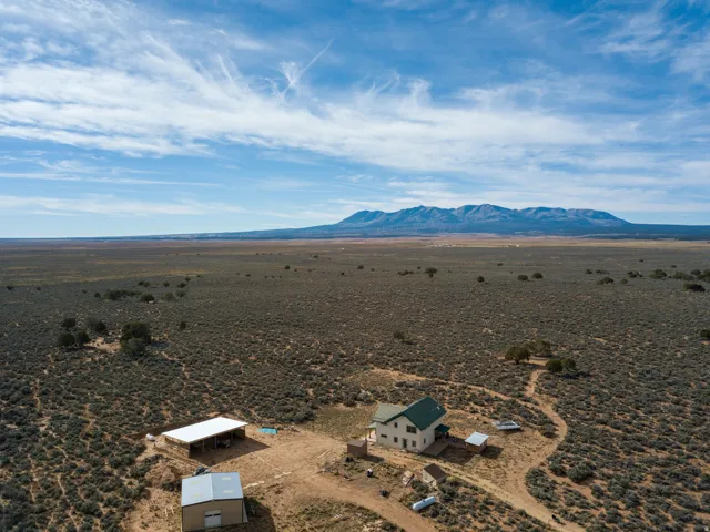 Aerial view of sparsely populated area with a desert landscape and a mountainous background