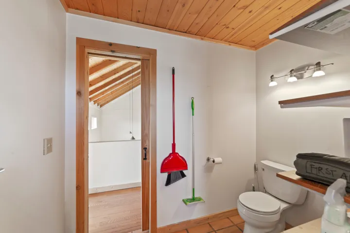 Bathroom featuring wood ceiling and tile patterned floors