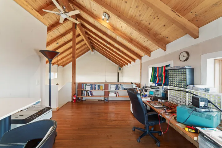 Office with wood ceiling and ceiling fan