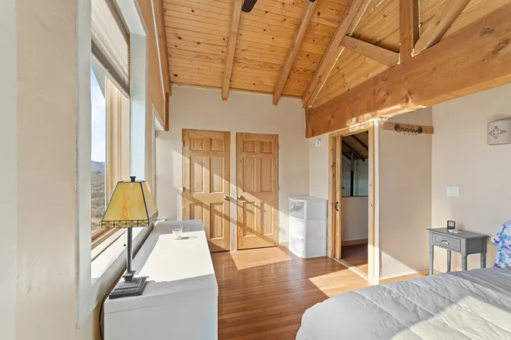 Bedroom with wood finished floors and wood ceiling