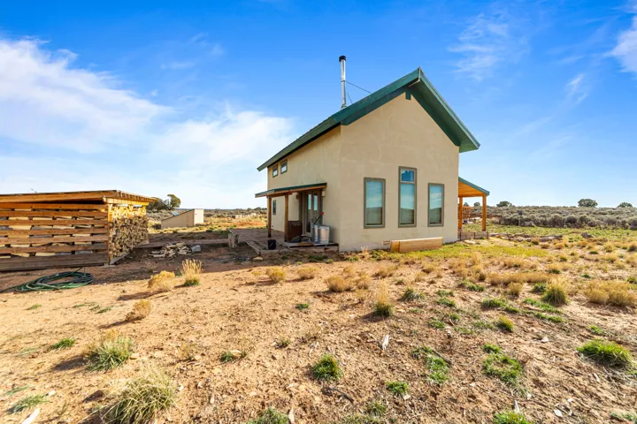 Rear view of house featuring stucco siding and a patio area