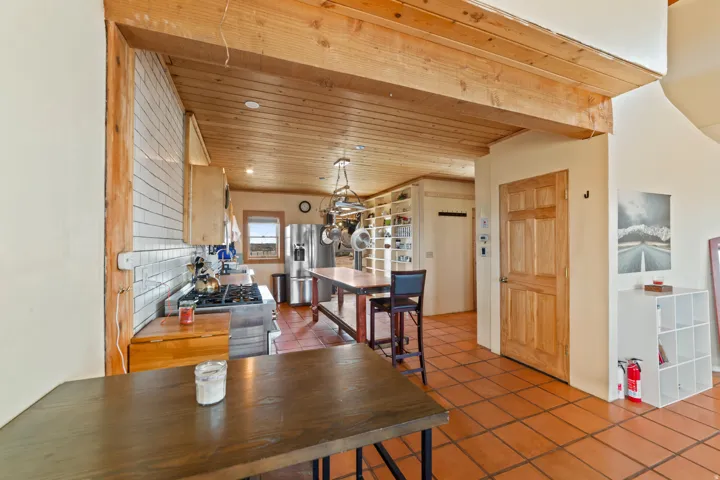Tiled dining room featuring wood ceiling and recessed lighting