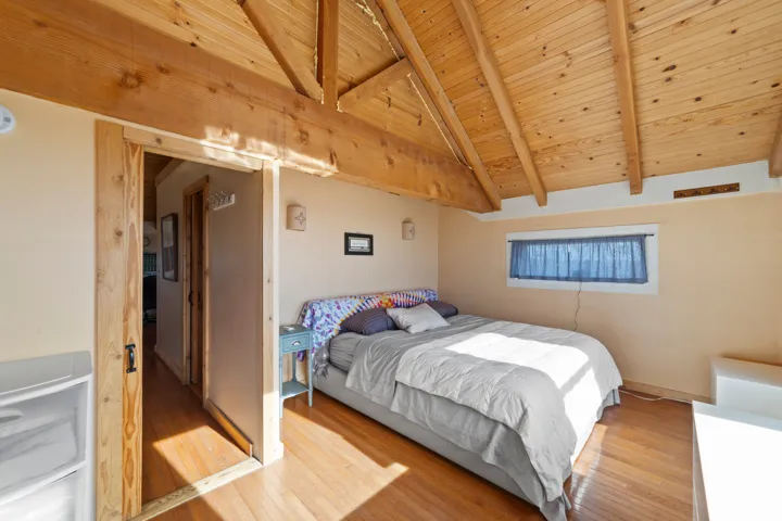Bedroom featuring wood-type flooring and wooden ceiling