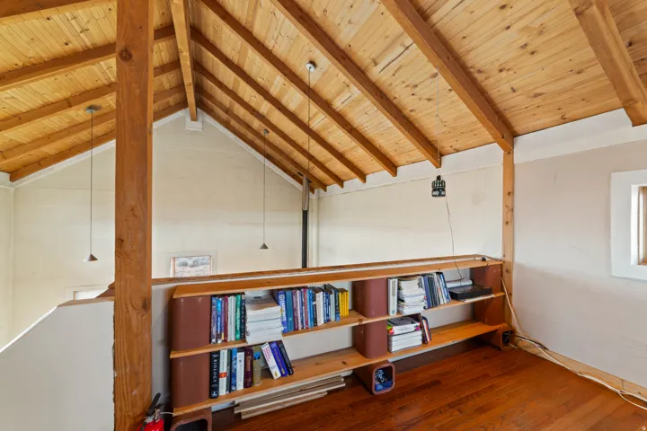Living area with dark wood-type flooring and wooden ceiling