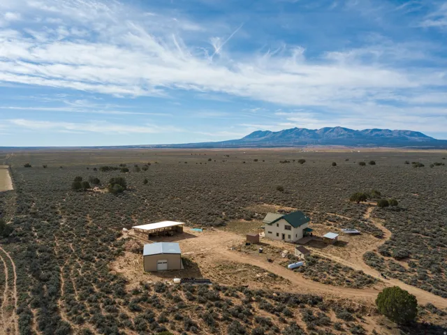 Overview of rural landscape featuring a mountain backdrop and a desert landscape