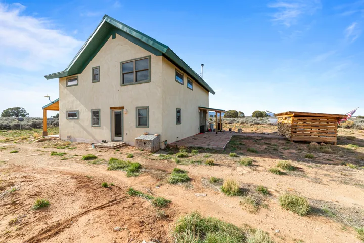 Rear view of house with a patio area and stucco siding