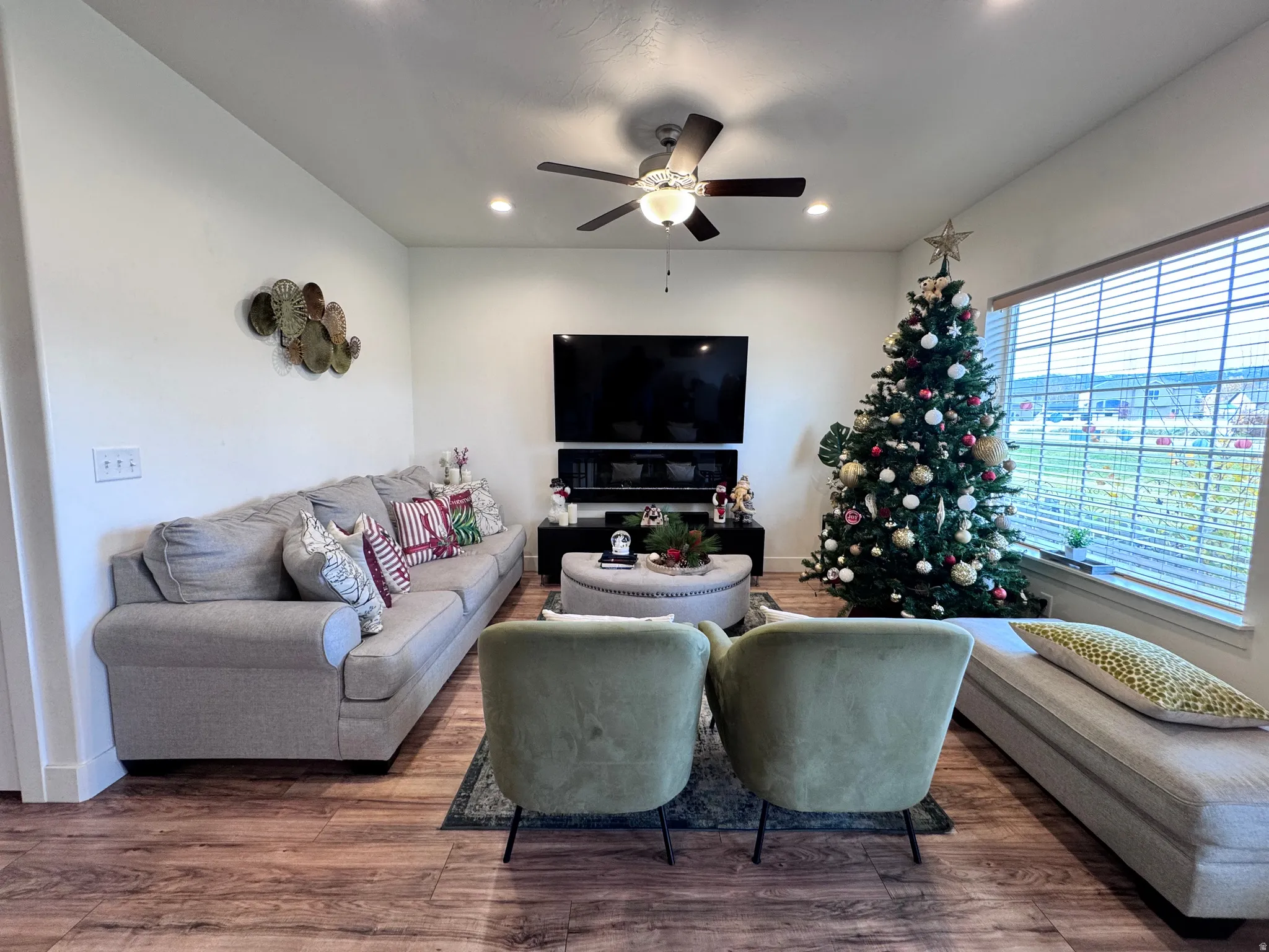 Living room featuring a ceiling fan, wood finished floors, and recessed lighting