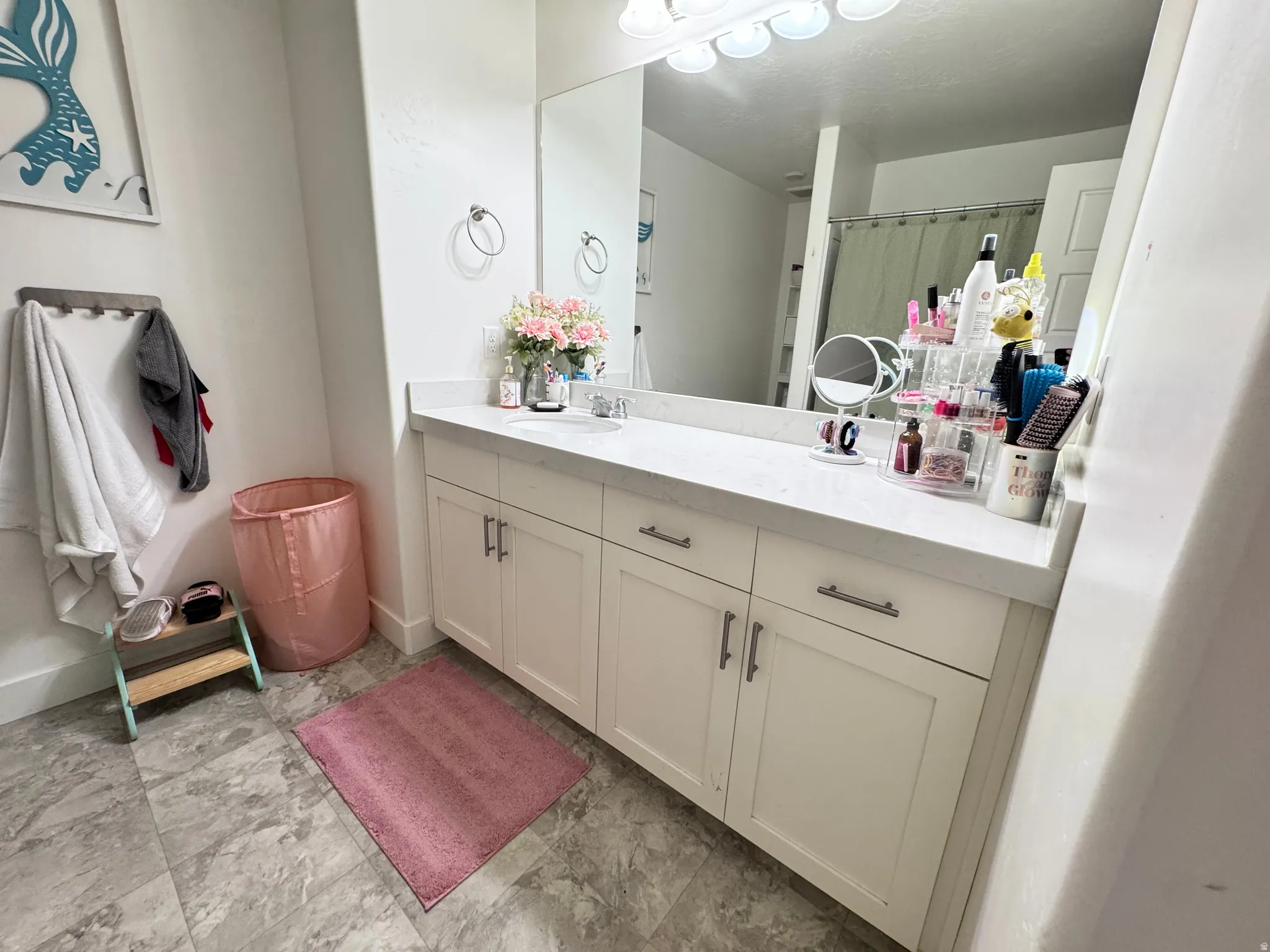 Bathroom with vanity and curtained shower