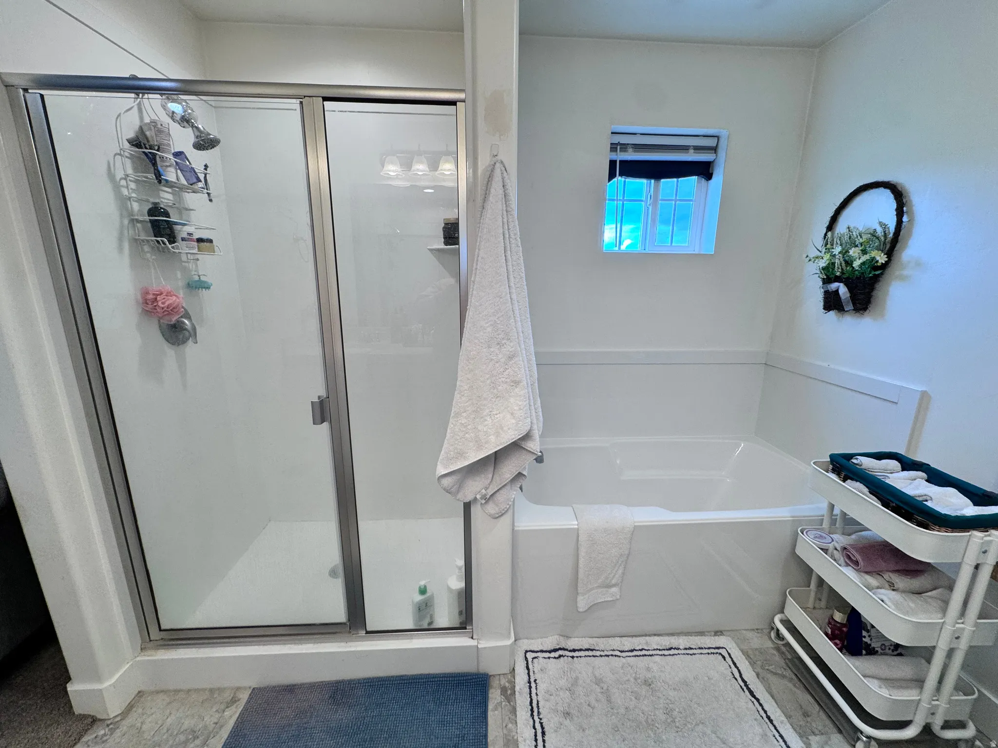 Full bath featuring a garden tub and a stall shower