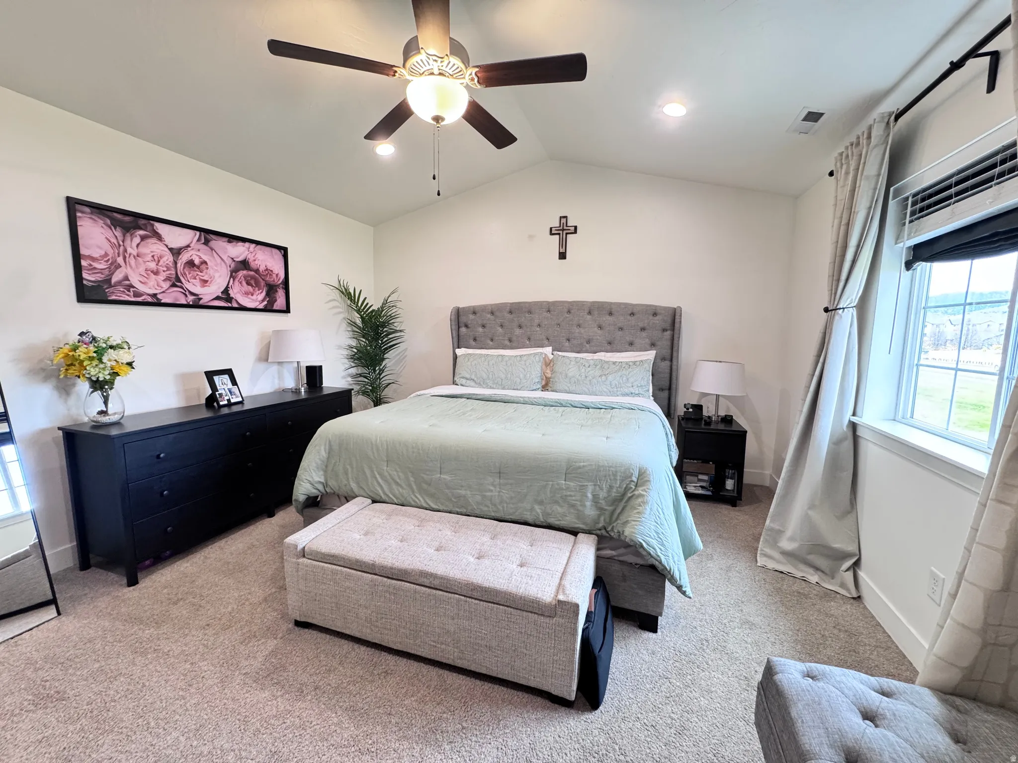 Bedroom featuring lofted ceiling, carpet flooring, and a ceiling fan