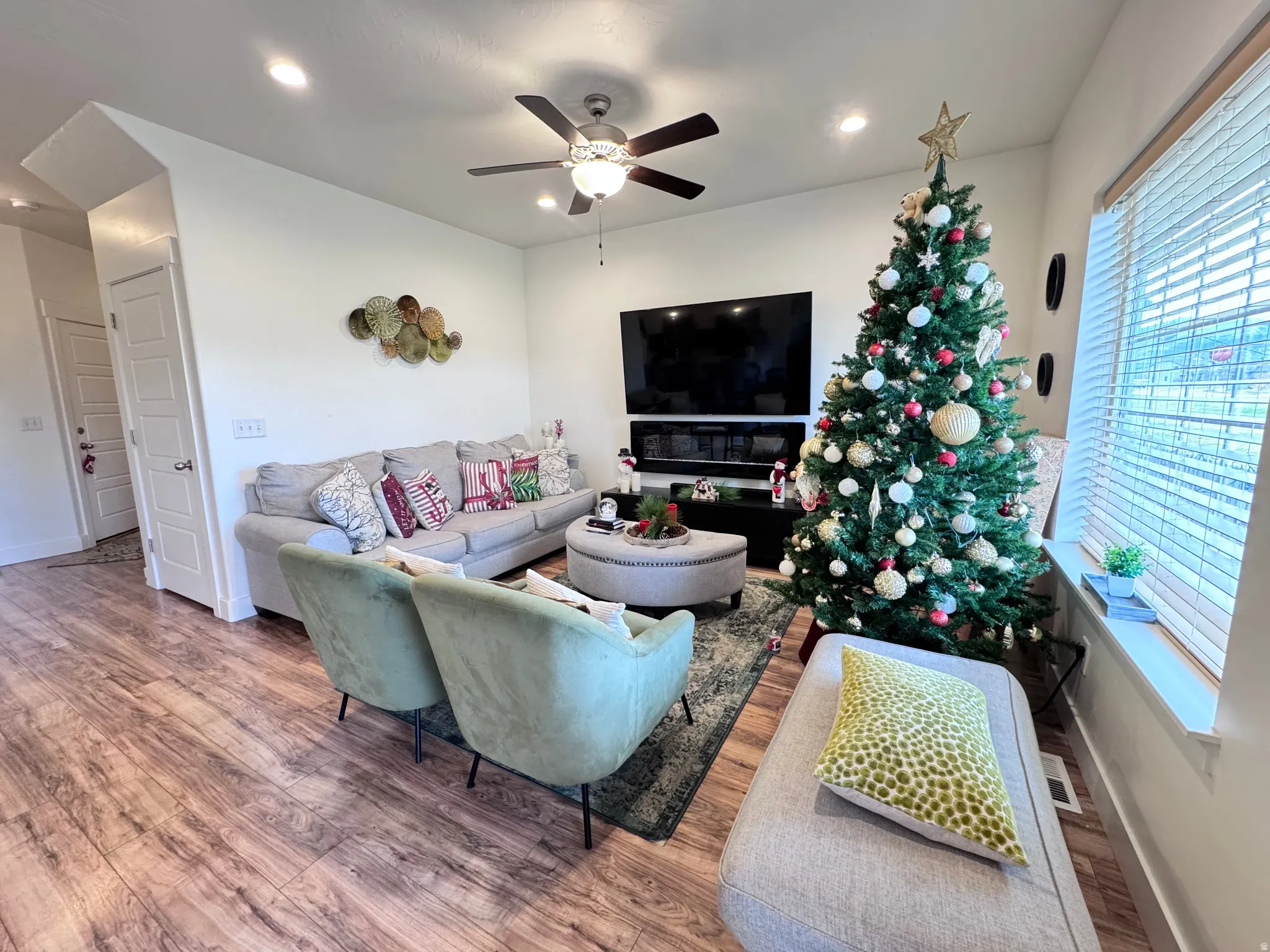 Living room featuring wood finished floors, a ceiling fan, and recessed lighting