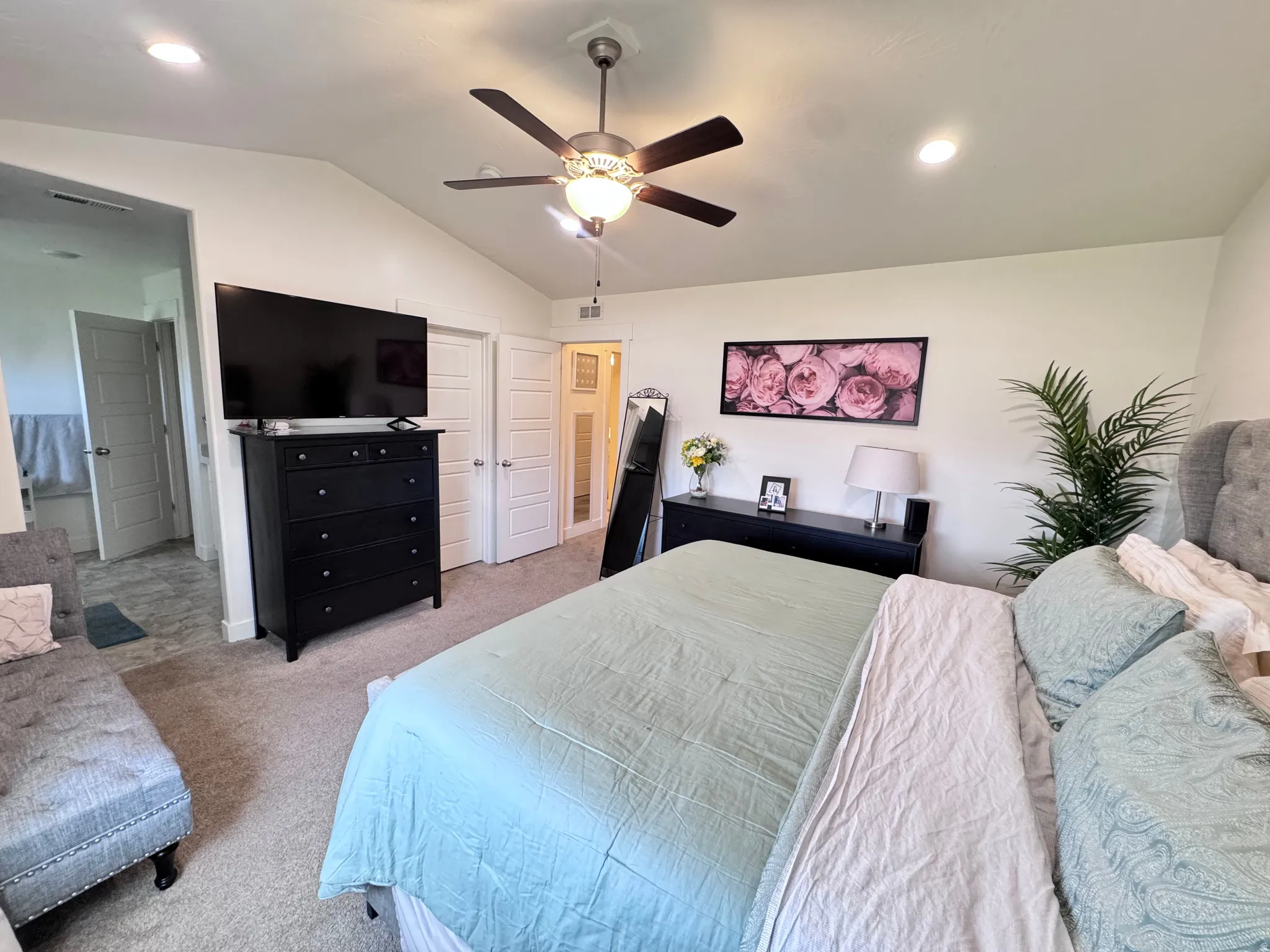 Bedroom featuring lofted ceiling, light colored carpet, ceiling fan, and recessed lighting