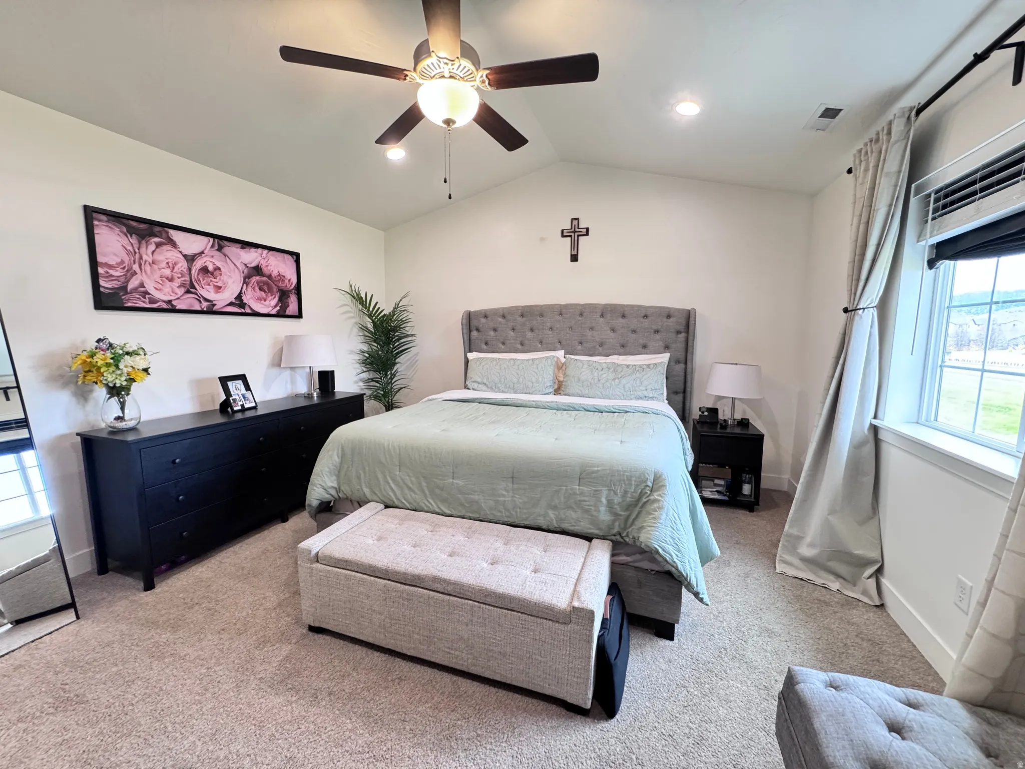 Bedroom featuring vaulted ceiling, carpet floors, and ceiling fan