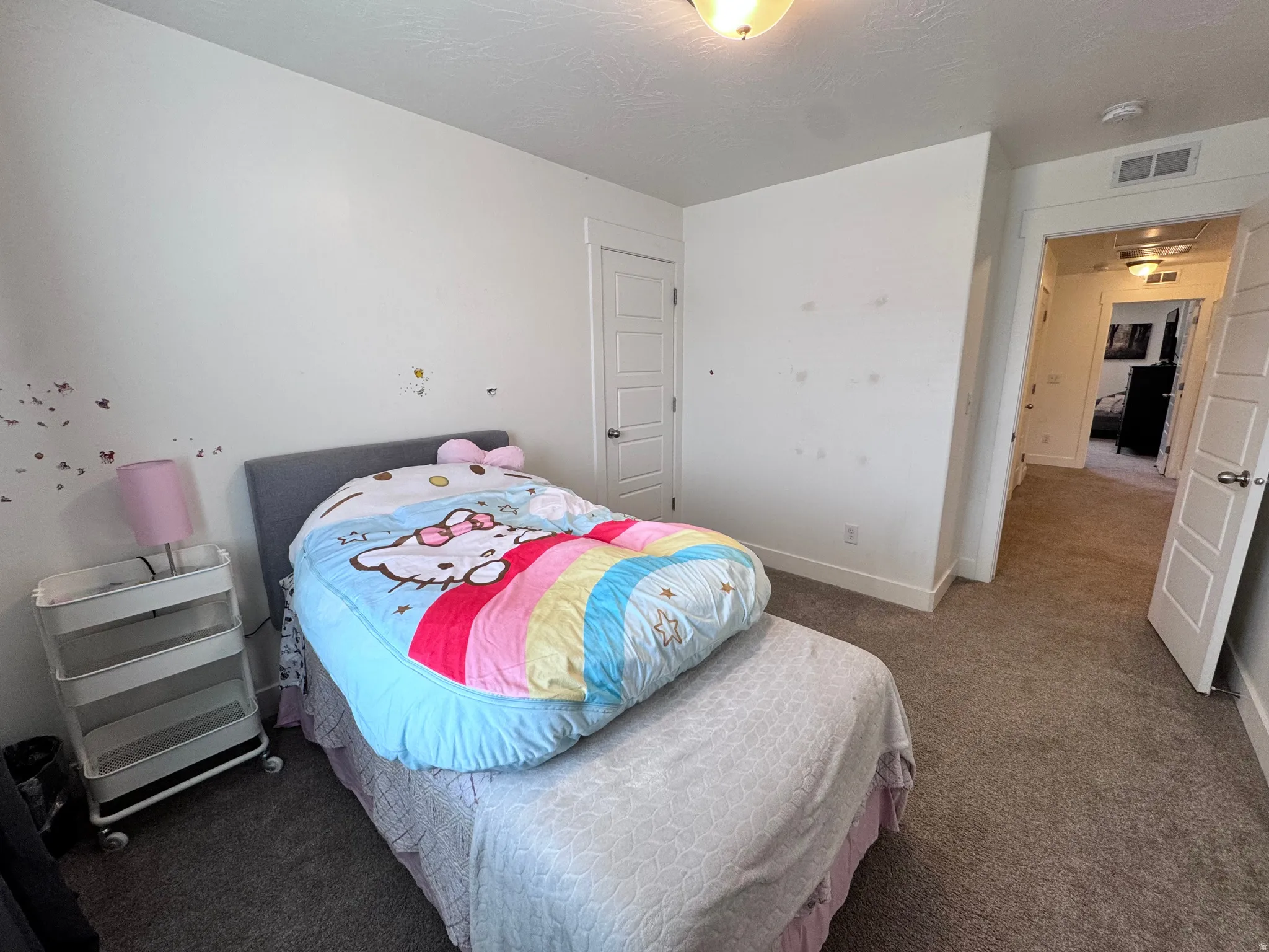 Bedroom featuring carpet and baseboards