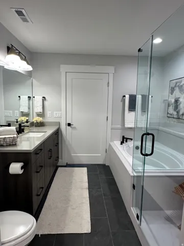 Full bath featuring vanity, a garden tub, a shower stall, dark tile patterned floors, and recessed lighting