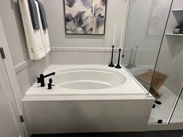 Full bath featuring a garden tub and a shower stall