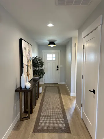 Entrance foyer with light wood-style floors and recessed lighting
