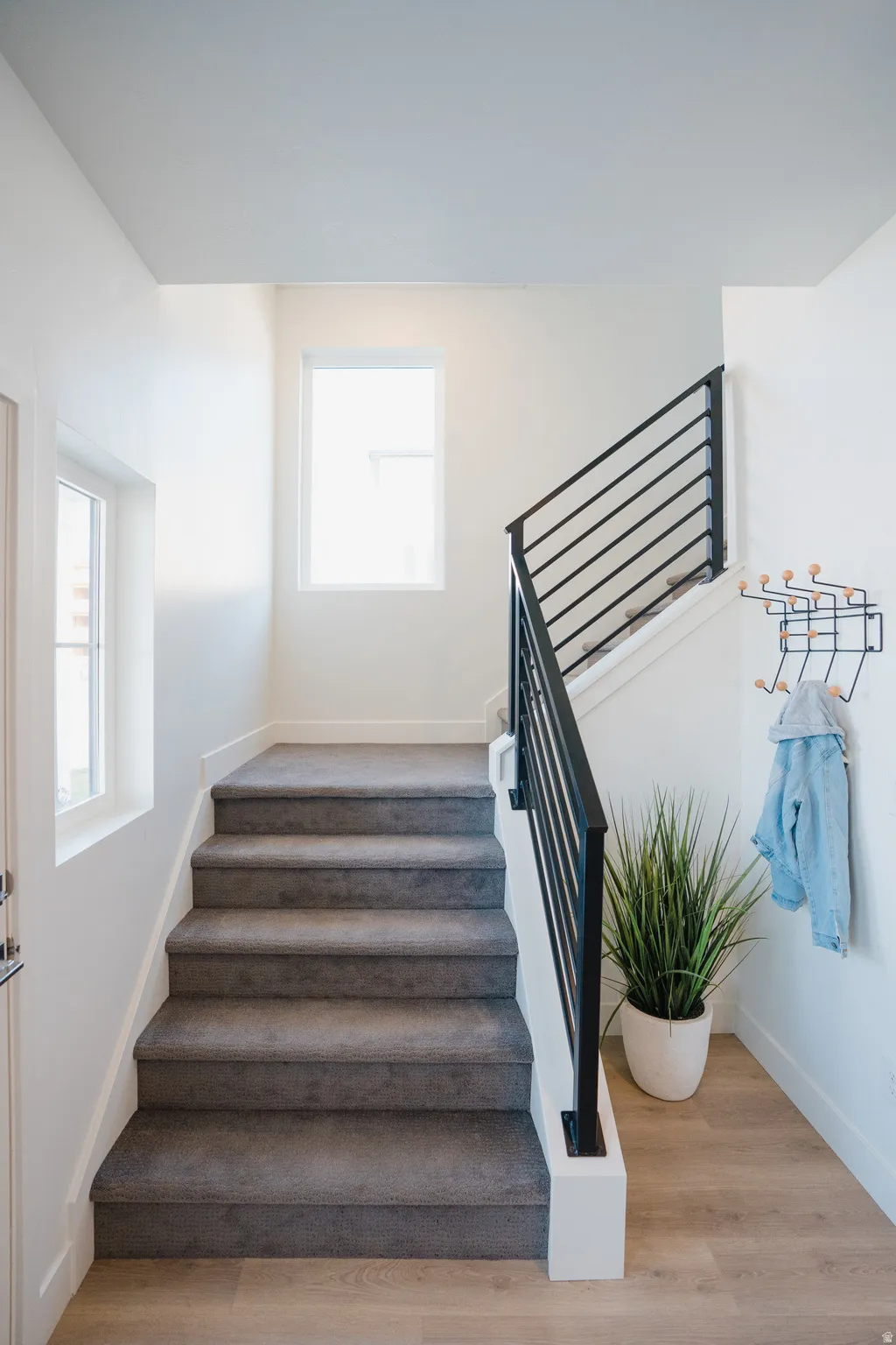 Stairs featuring wood finished floors and baseboards