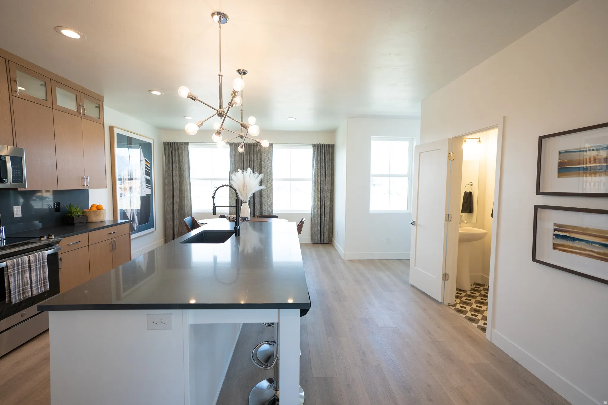 Kitchen with appliances with stainless steel finishes, healthy amount of natural light, a chandelier, hanging light fixtures, and recessed lighting