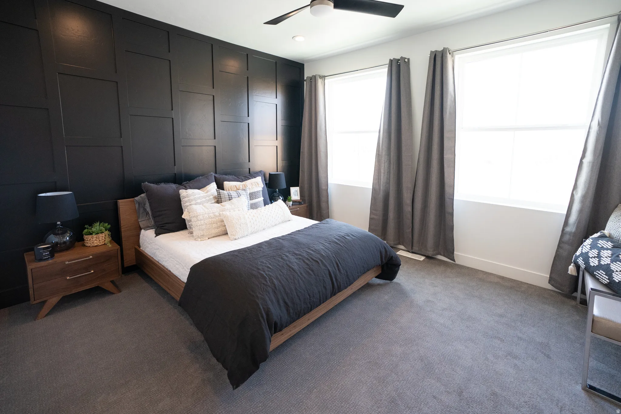 Carpeted bedroom featuring a ceiling fan and baseboards