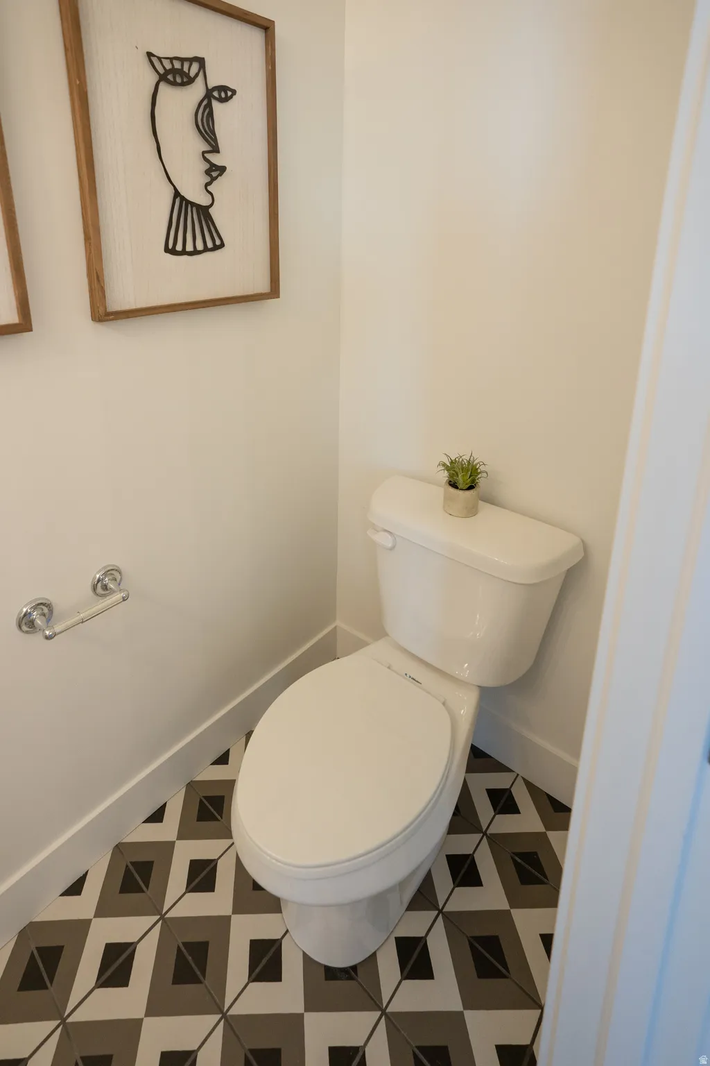 Bathroom featuring baseboards and toilet