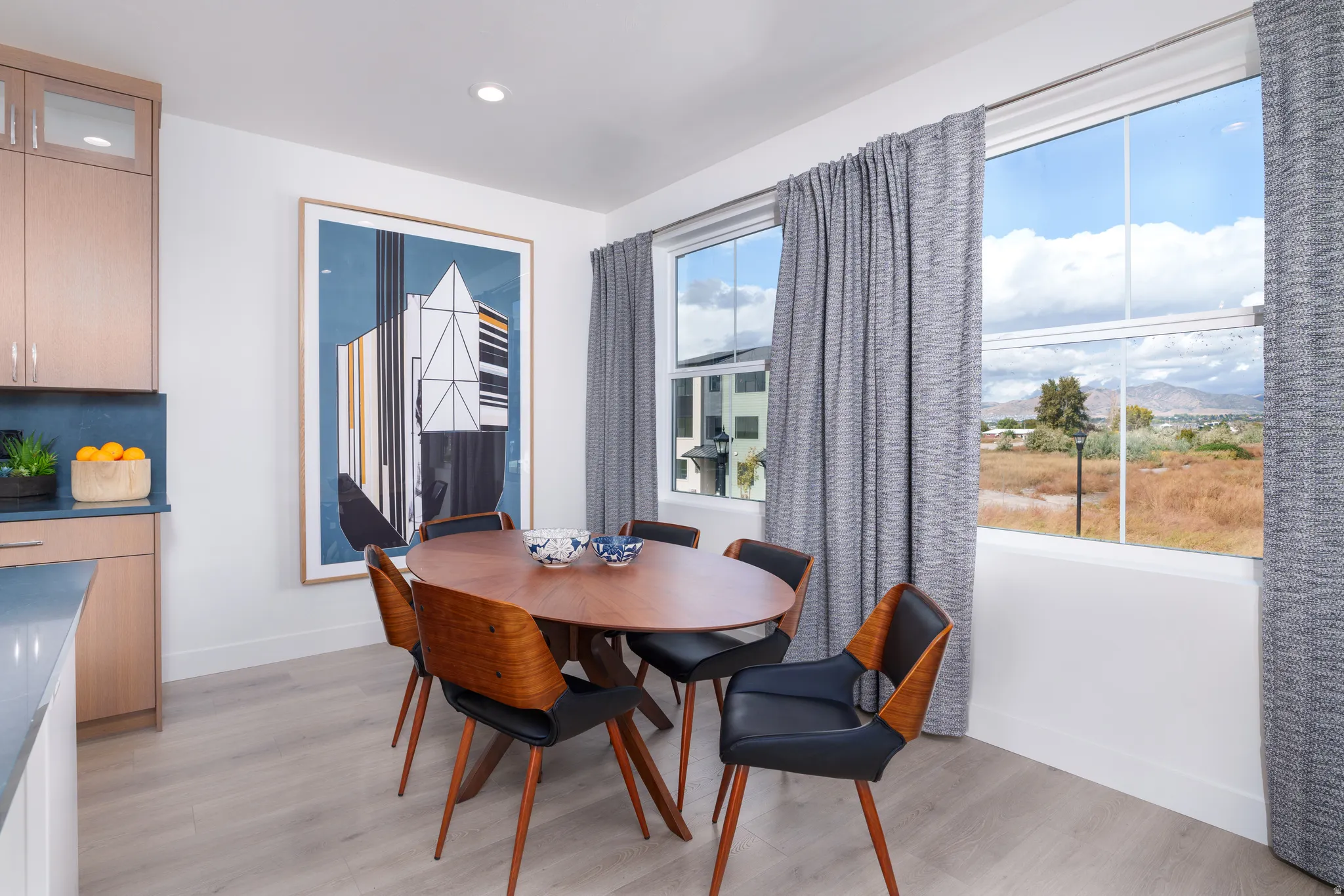 Dining room with light wood finished floors, recessed lighting, and a mountain view