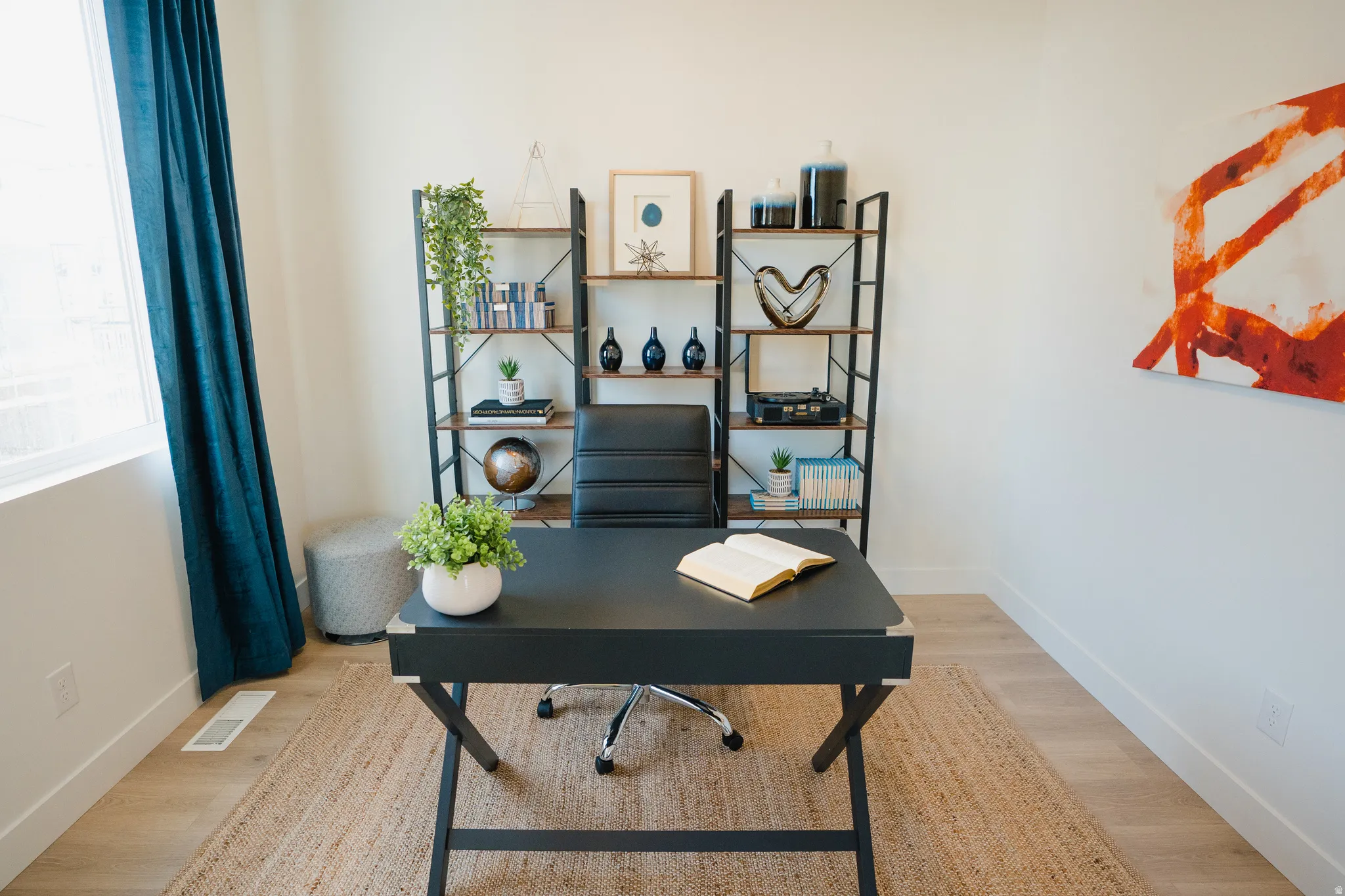 Home office featuring baseboards and light wood-style flooring