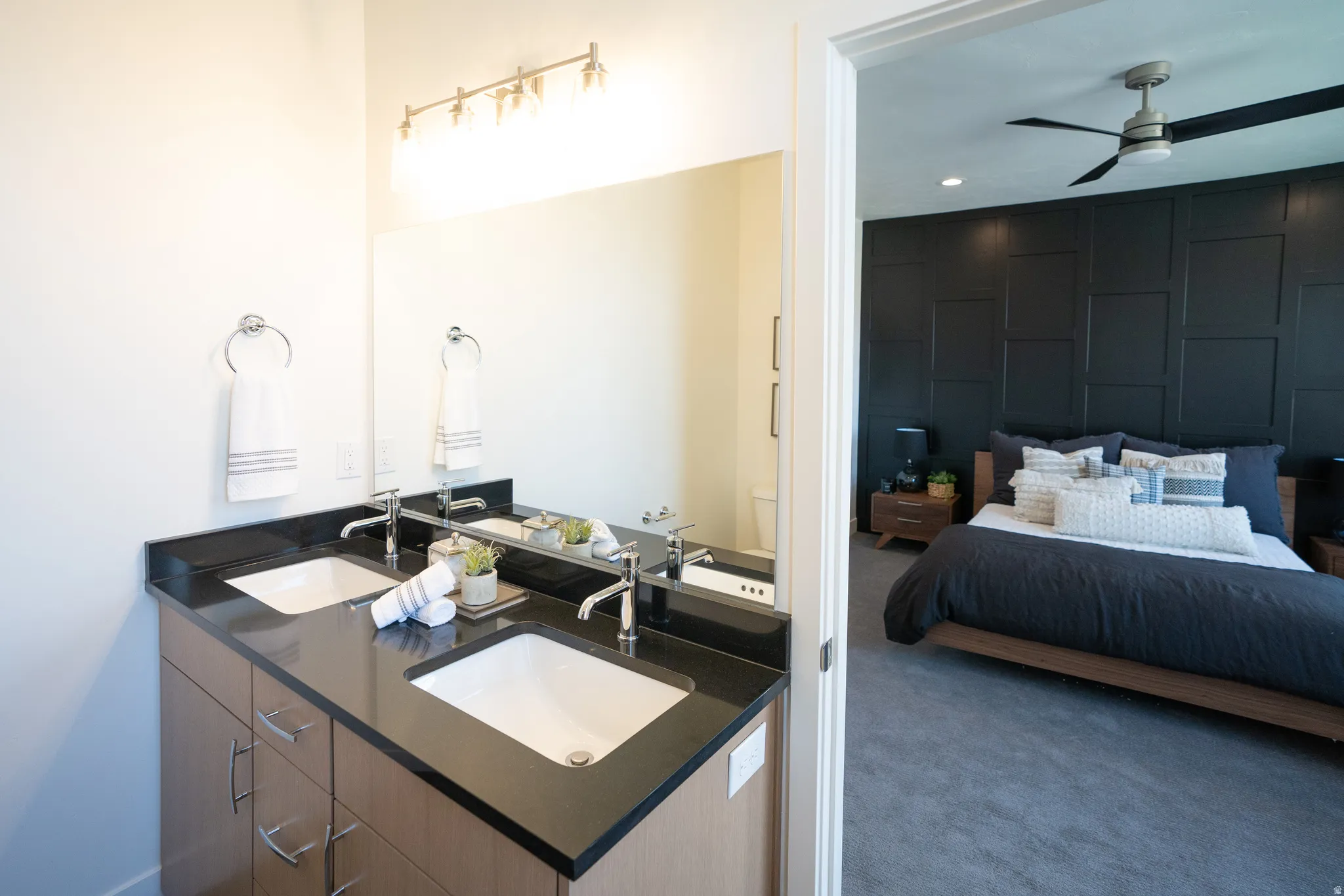 Ensuite bathroom featuring double vanity, carpet, a ceiling fan, and recessed lighting