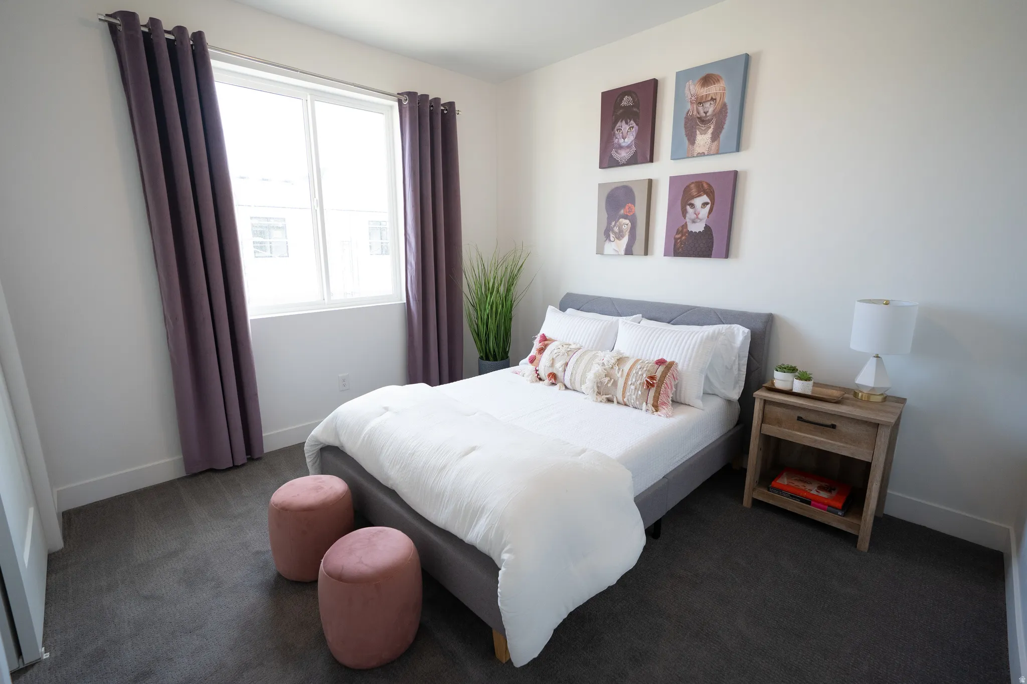 Bedroom featuring baseboards and dark carpet