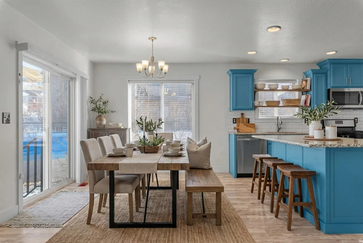 Dining space featuring a chandelier, light wood finished floors, and recessed lighting