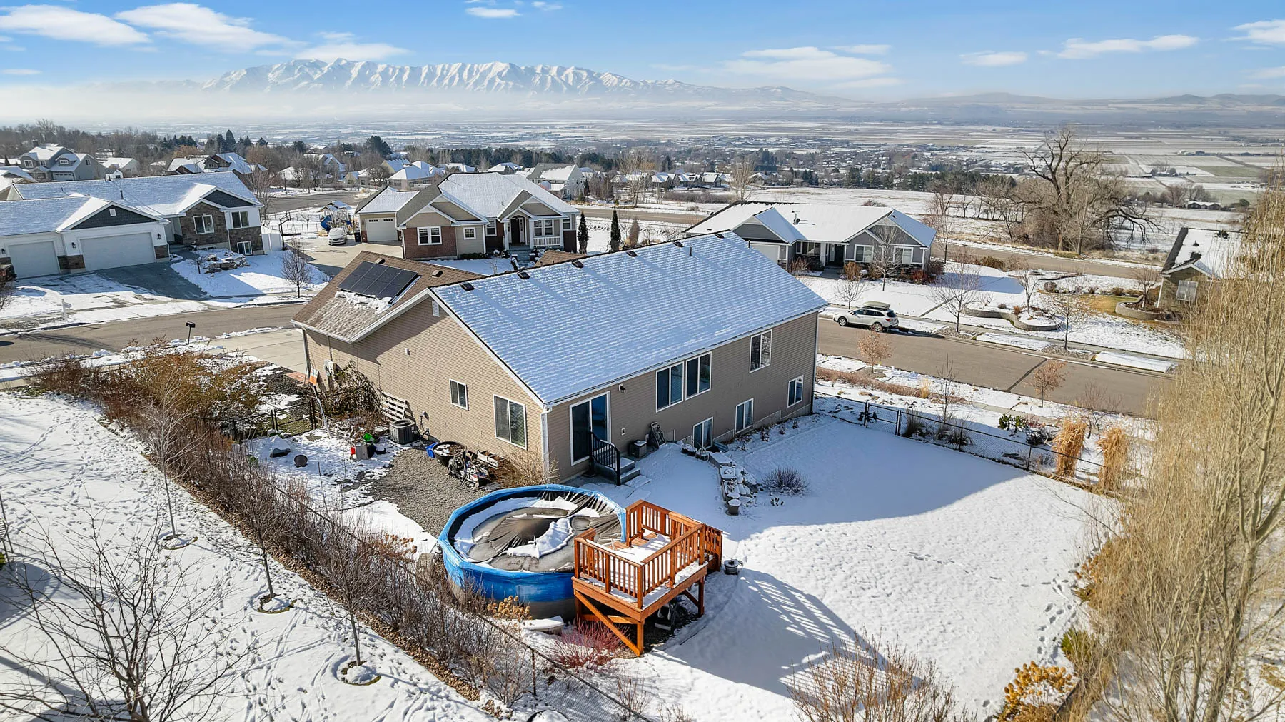 Snowy aerial view with a mountain view and a residential view