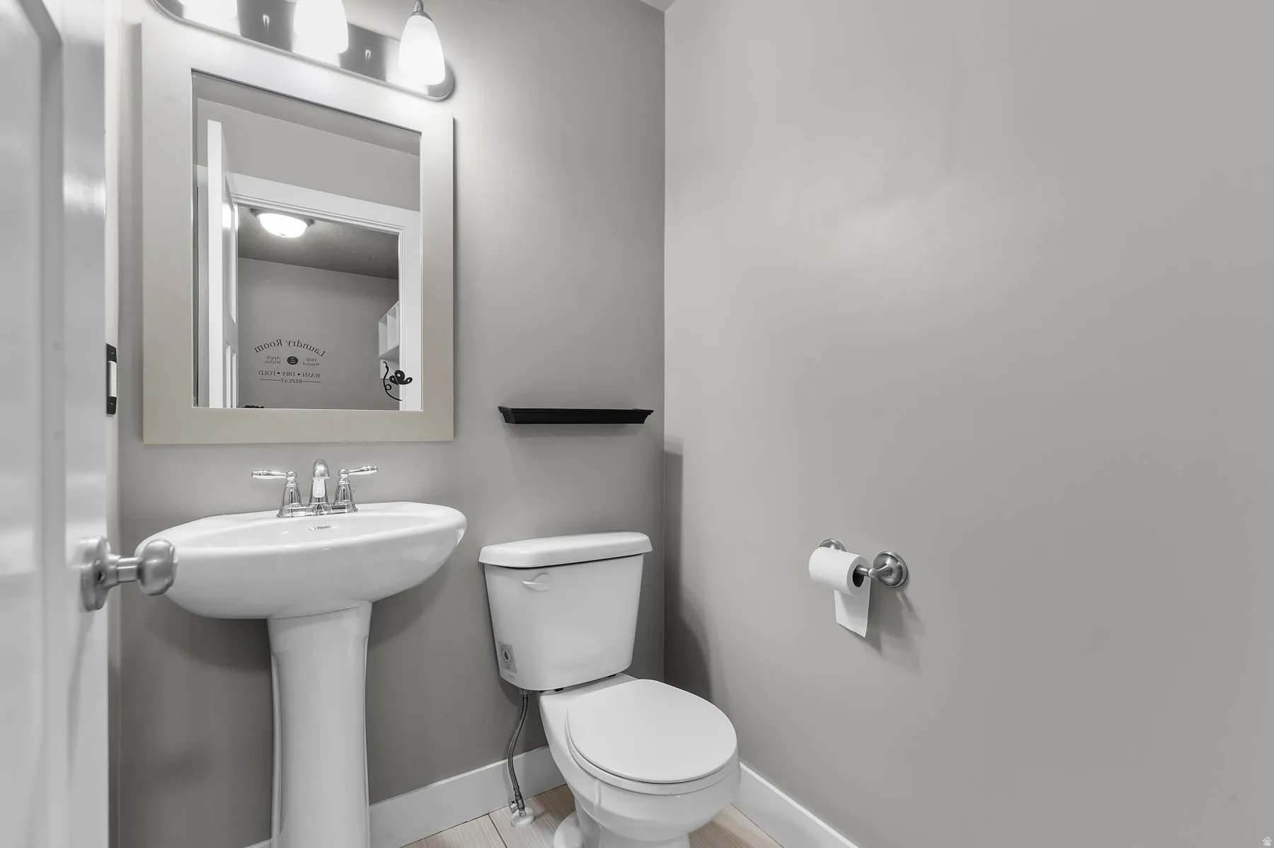 Half bath featuring baseboards