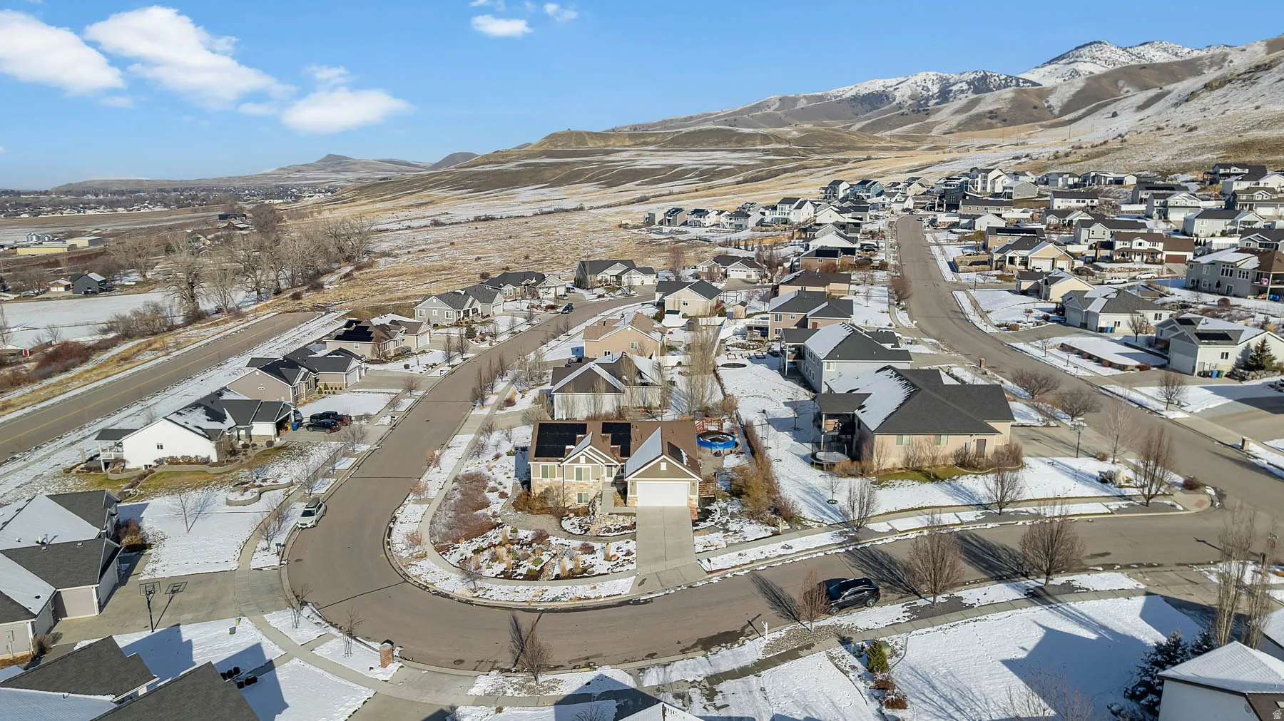 Snowy aerial view with a residential view and a mountain view