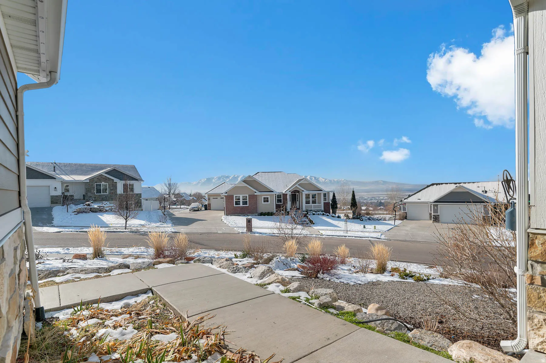 Snow covered patio featuring a residential view
