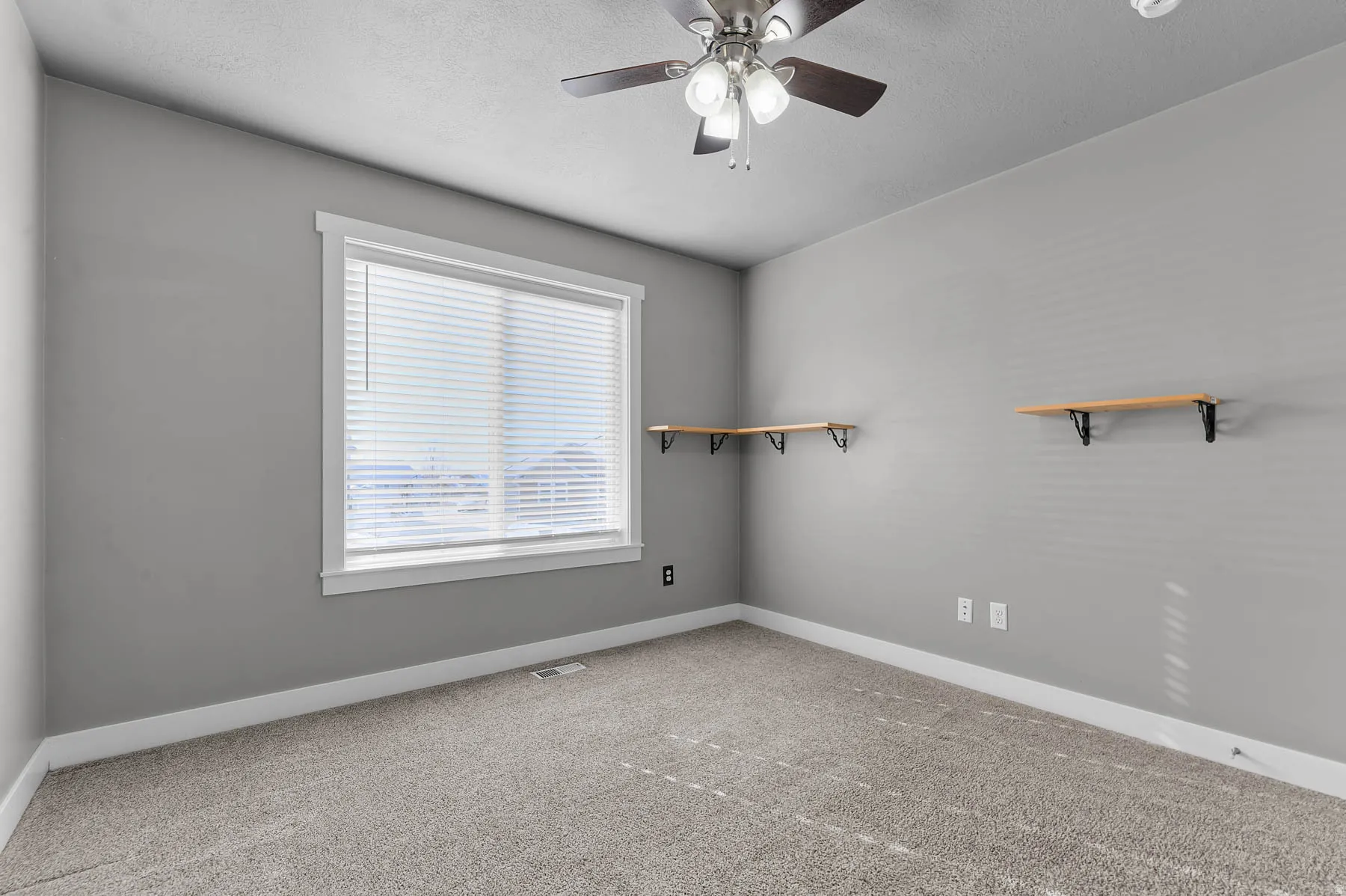 Spare room with carpet, ceiling fan, and a textured ceiling