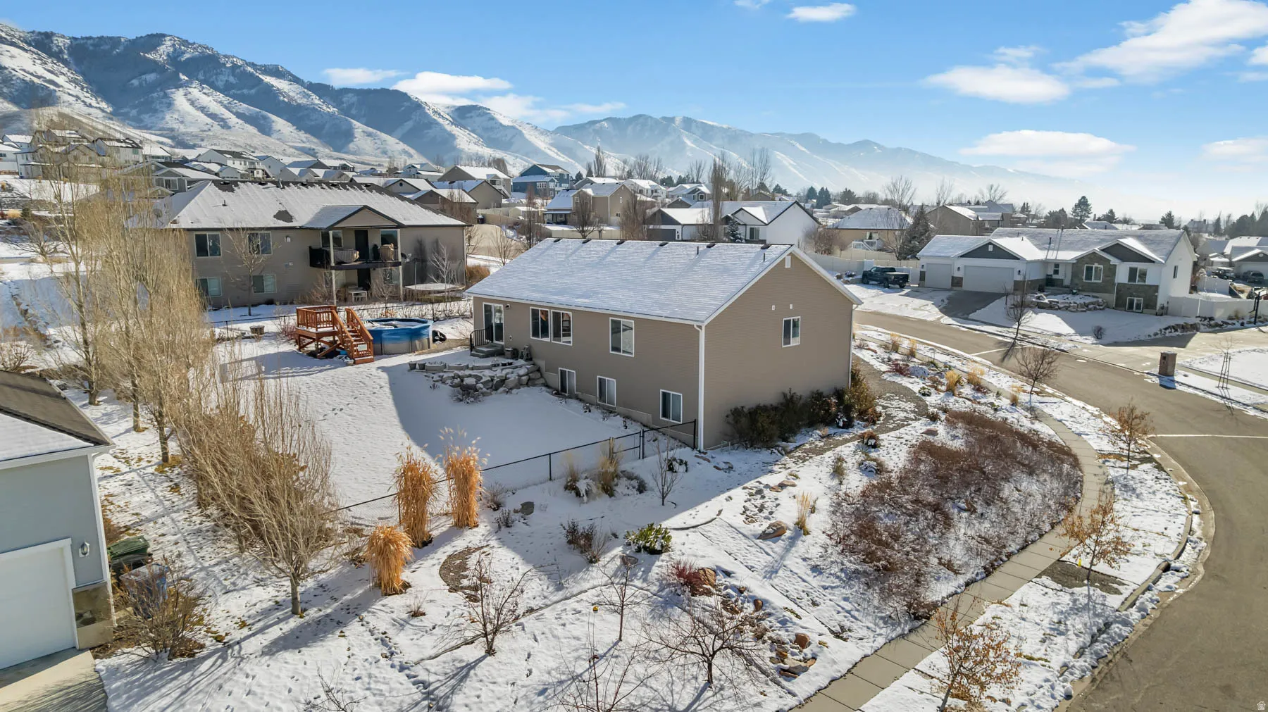 Snowy aerial view with a residential view and a mountain view