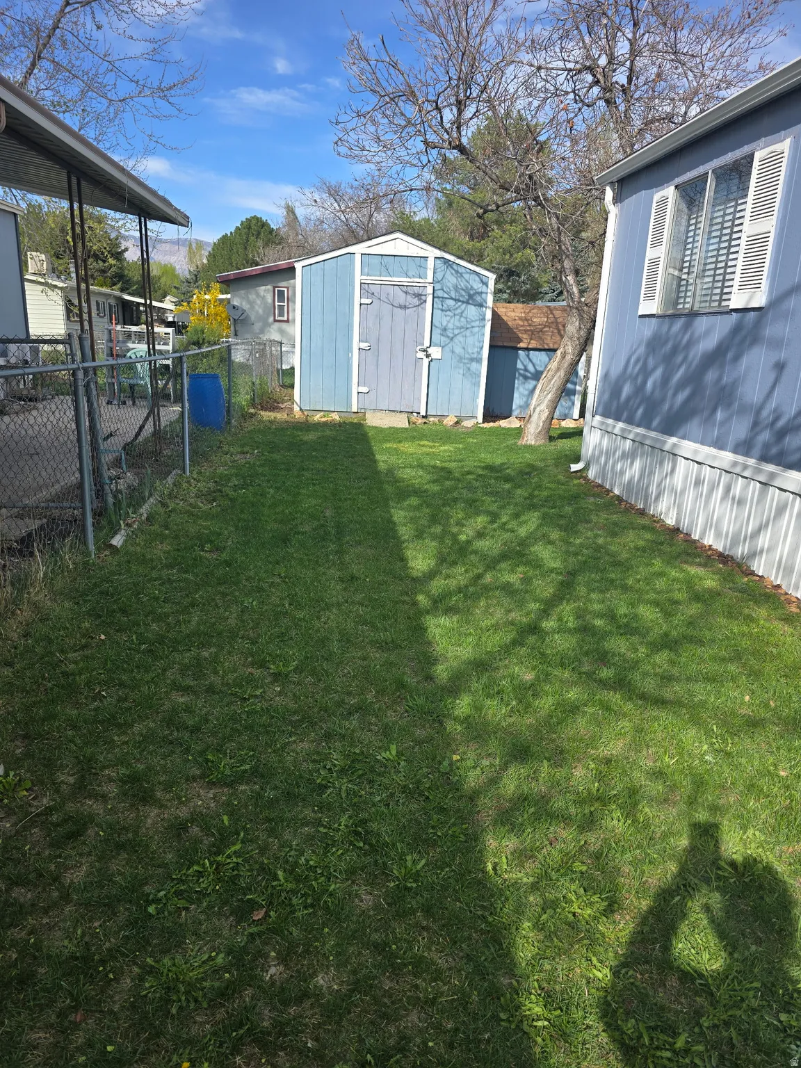 View of yard with a storage unit