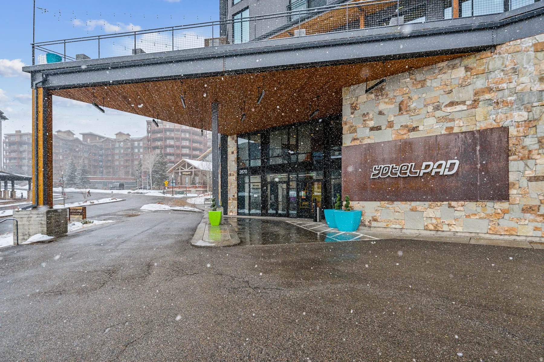 View of exterior entry featuring stone siding
