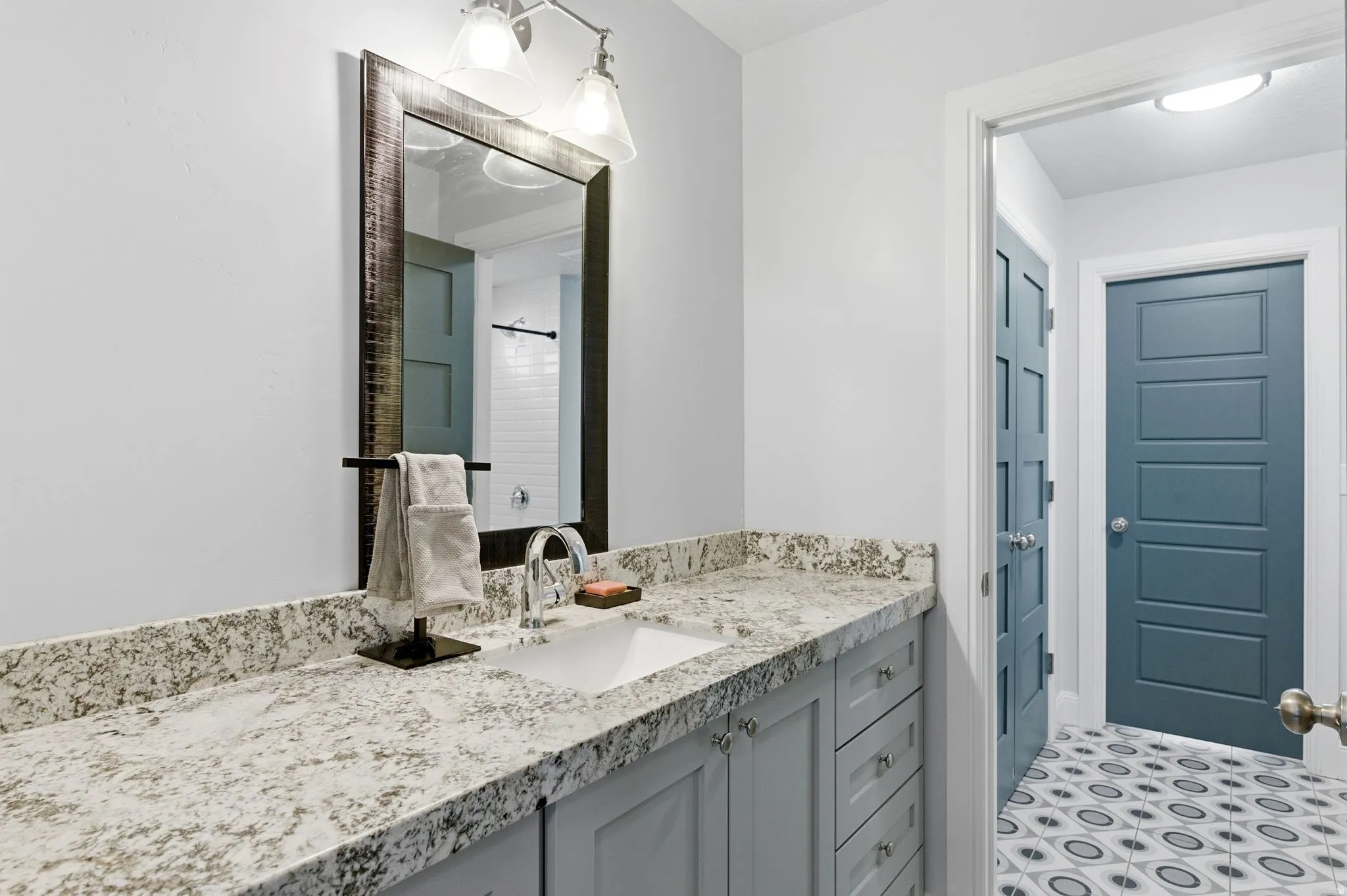 Full bath with vanity and a shower