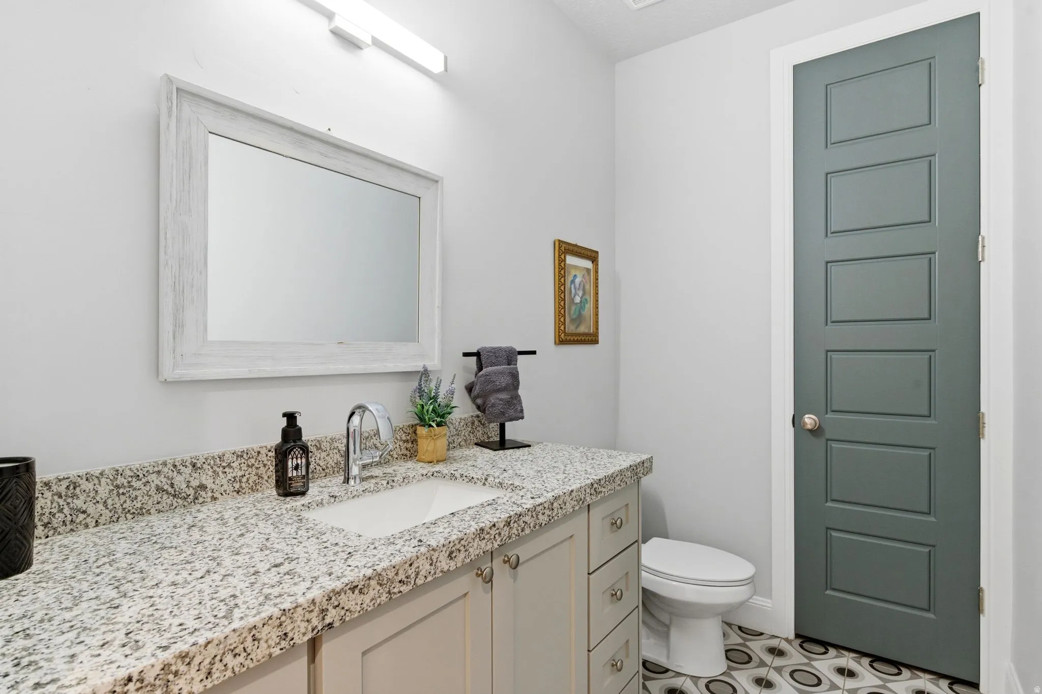 Half bath with vanity and toilet